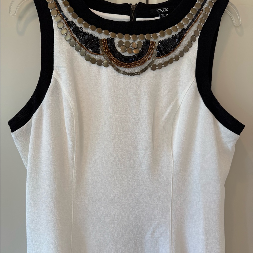 NWOT. Off-white OXOX Dress with Black trim
and Metal Embellishment. Size 13-14